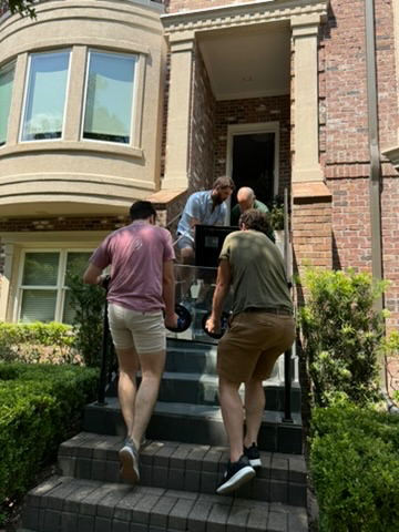 A group of men standing on stairs  Description automatically generated