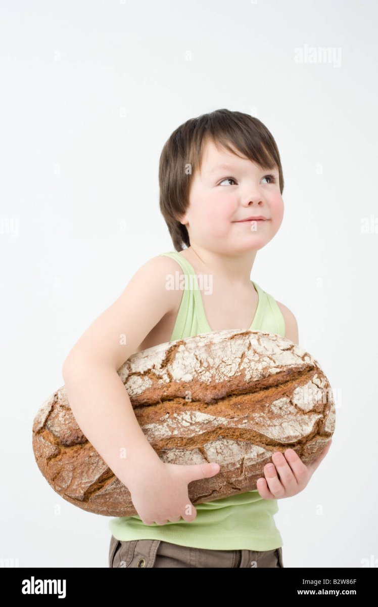 boy-holding-loaf-of-bread-B2W86F.jpg