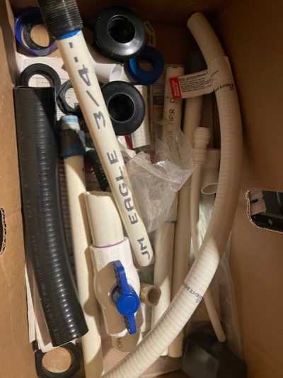 Box full of various plumbing parts- Tubes, strainers, elbows, bulkheads, shut offs, loclines and more
